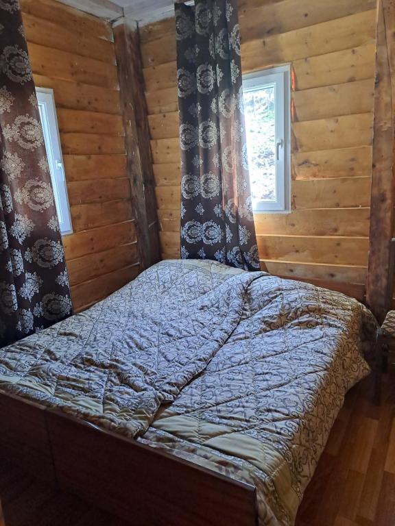 a bedroom with a bed in a log cabin at Sweet home in Lalkhori
