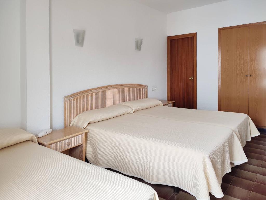 Postel nebo postele na pokoji v ubytování Hotel Porto