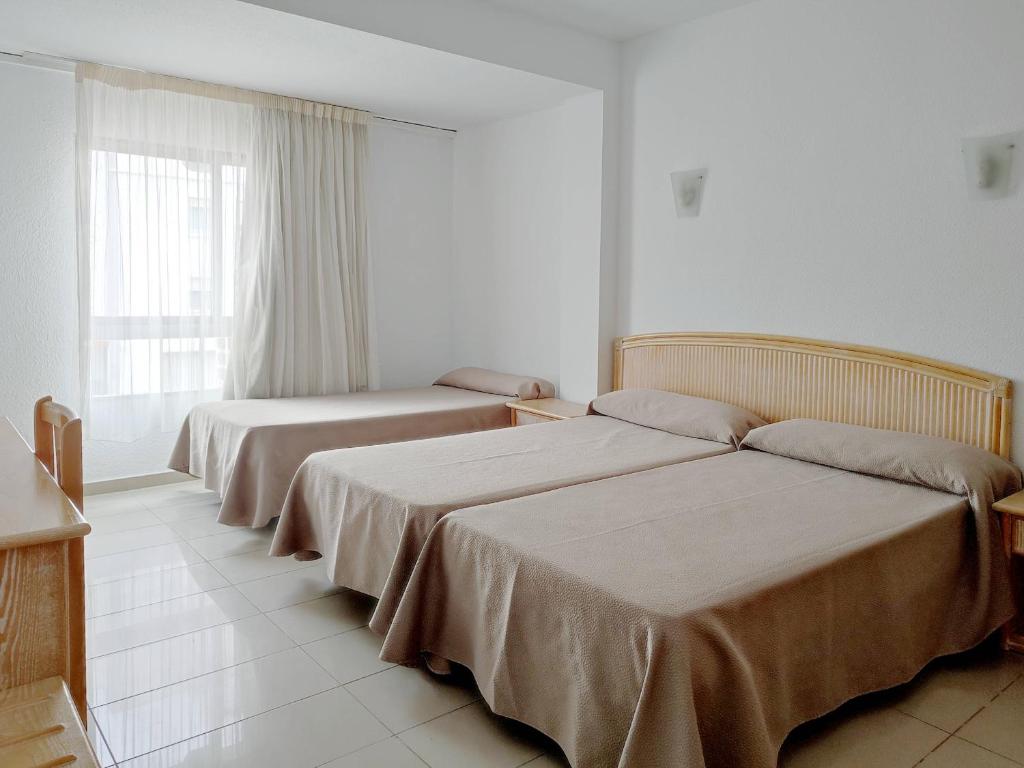 Postel nebo postele na pokoji v ubytování Hotel Porto