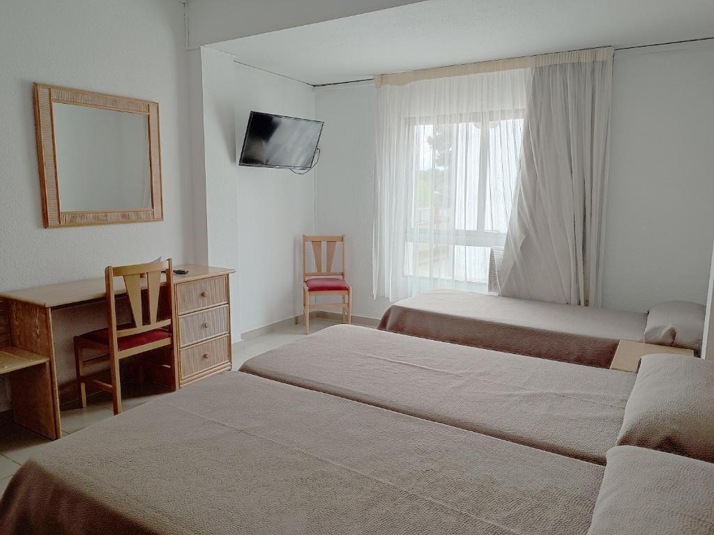 Postel nebo postele na pokoji v ubytování Hotel Porto