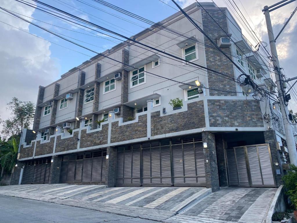 a building with two garage doors in front of it at ABE Lodge Taguig in Manila