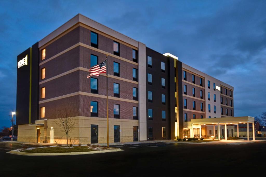 a building with an american flag in front of it at Home2 Suites By Hilton Bowling Green, Oh in Bowling Green