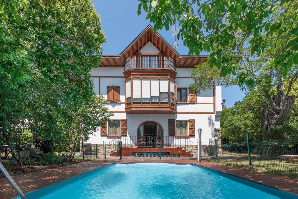 a house with a swimming pool in front of it at Villa Ganbara in Villava