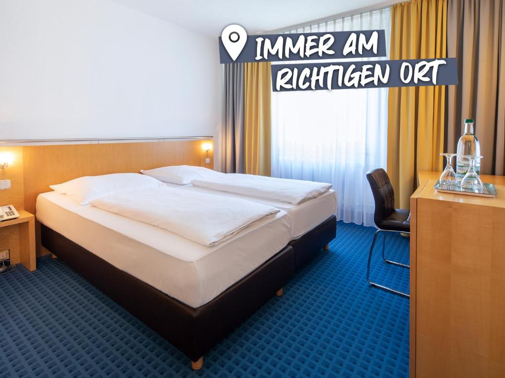 a bed in a hotel room with the words inner an kitchen off at ACHAT Hotel Suhl in Suhl