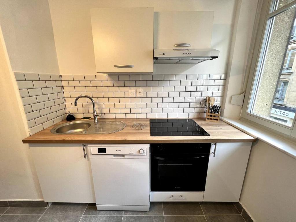 a small kitchen with a sink and a stove at Appartement Turquoise - 2 pers - Sedan in Sedan