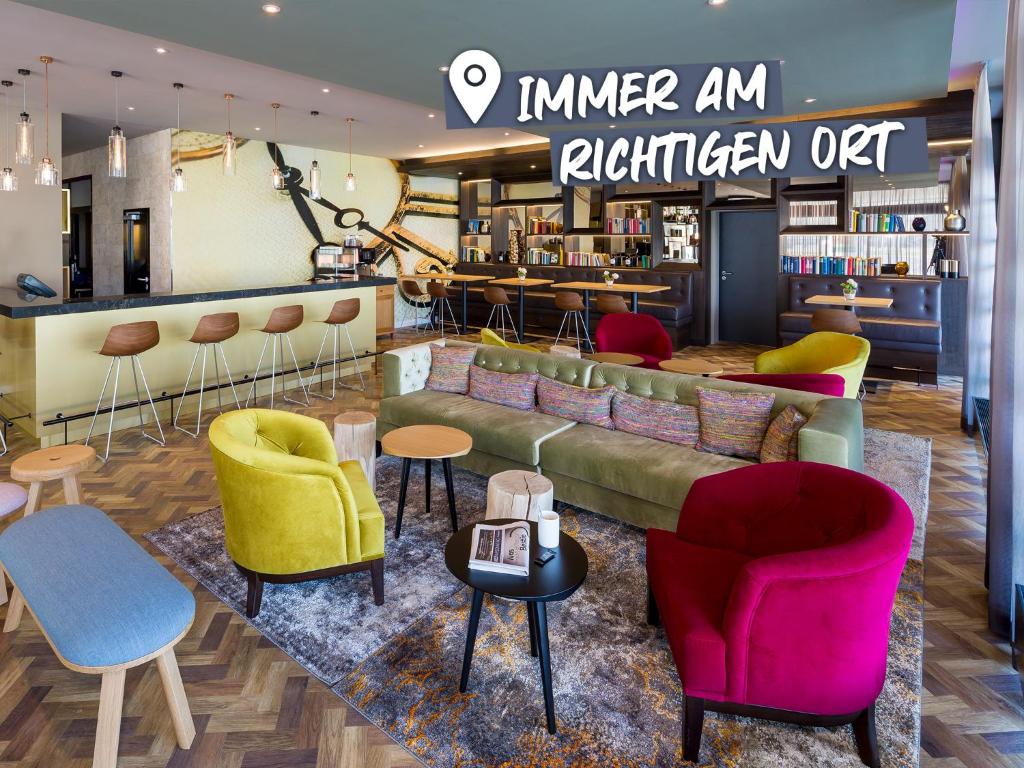 a store with a couch and chairs and tables at ACHAT Hotel Braunschweig in Braunschweig