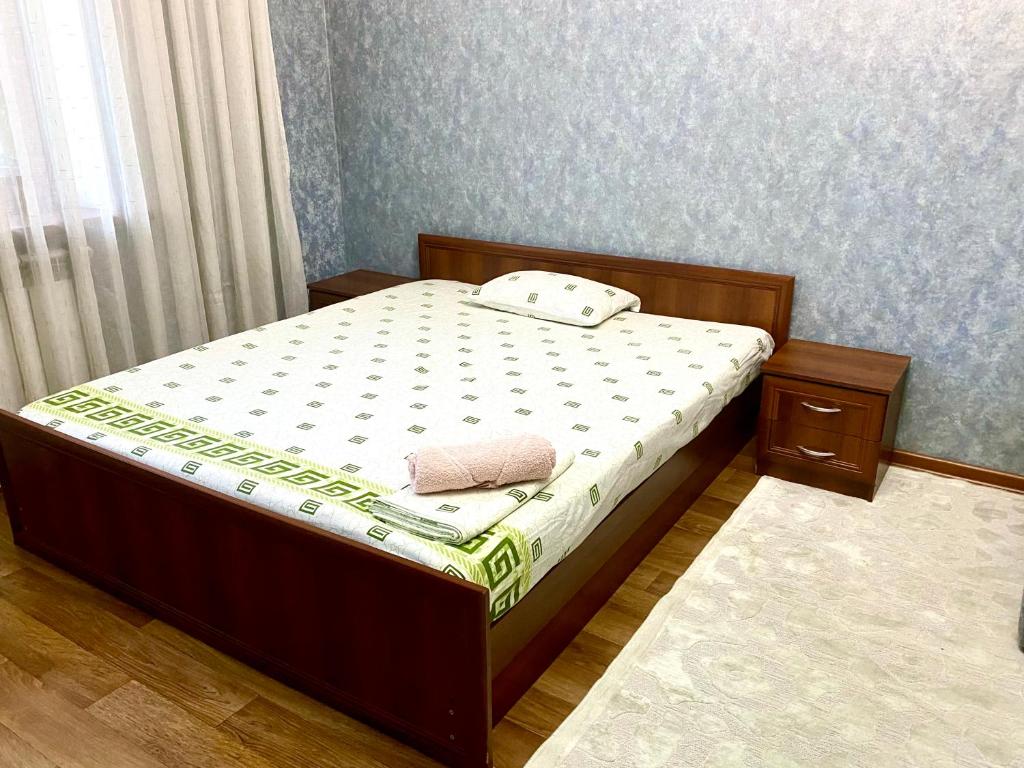 a small bedroom with a bed with at Майлина 10 аэропорт in (( Turksib ))