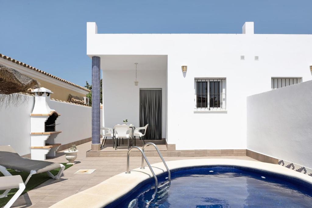 a house with a swimming pool and a patio at Casa Cala del Aceite 1 in Conil de la Frontera