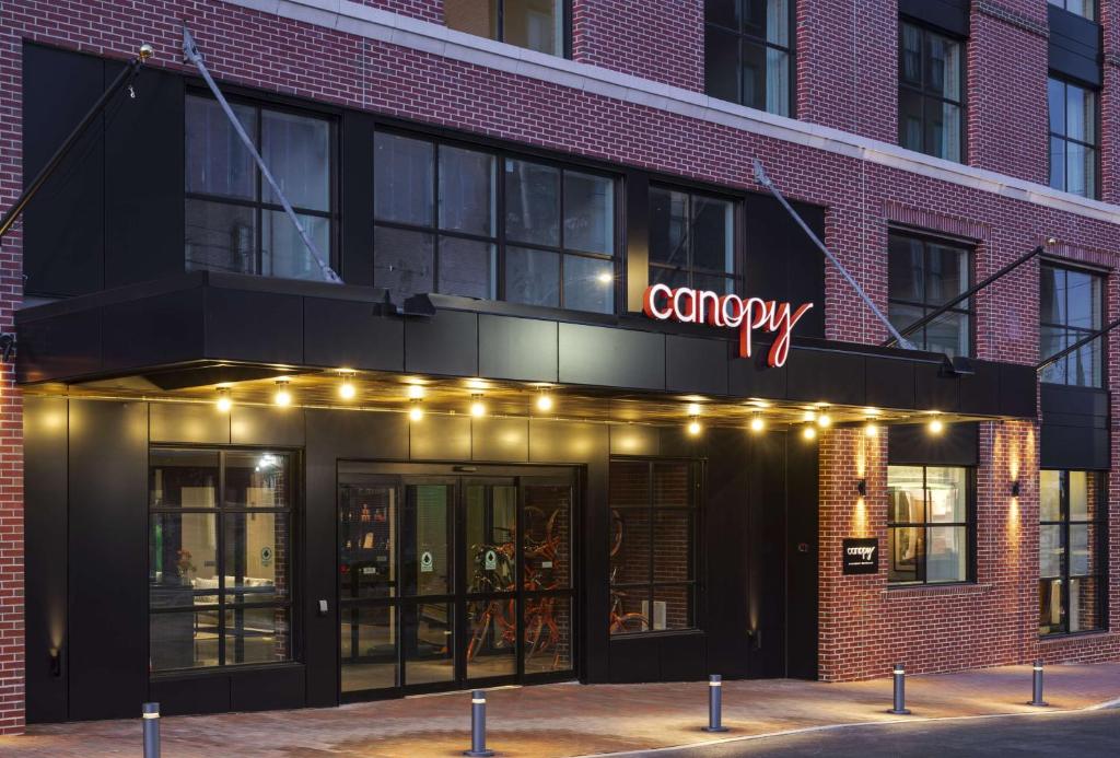 a company sign on the front of a brick building at Canopy By Hilton Portland Waterfront in Portland