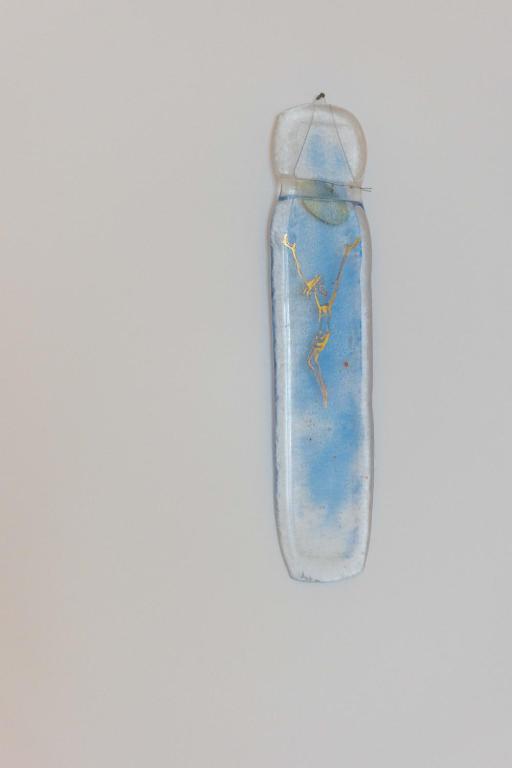 a blue bottle hanging on a white wall at Miranda's Place in Split