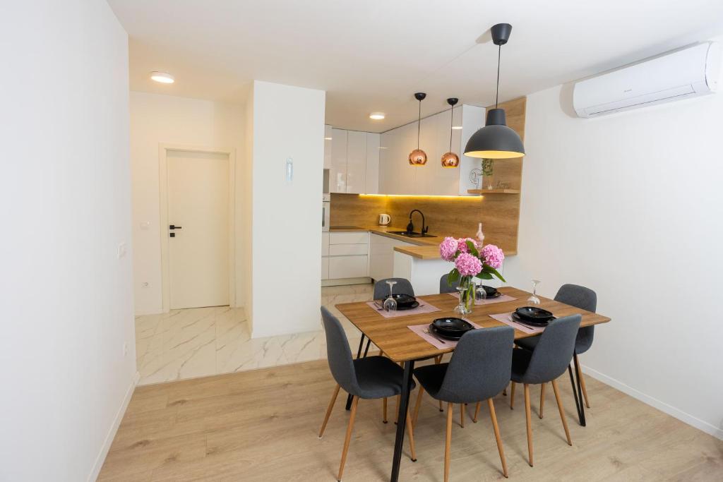 a kitchen and dining room with a wooden table and chairs at Miranda's Place in Split