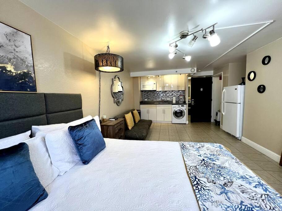a bedroom with a large bed and a living room at KING BED, Spacious, Legal, VIEW in Honolulu