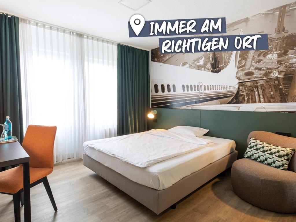 a hotel room with a bed and an airplane mural at ACHAT Hotel Frankfurt Airport in Langen