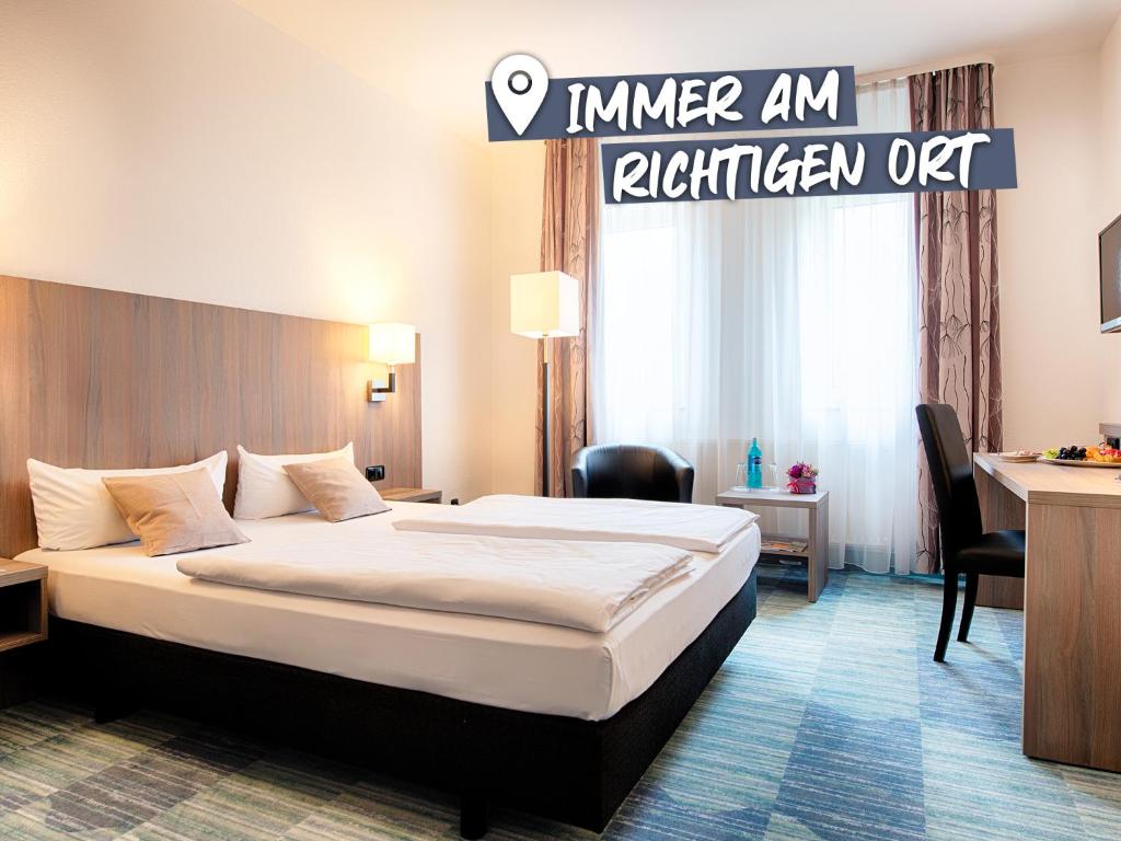 Postel nebo postele na pokoji v ubytování ACHAT Hotel Bochum Dortmund