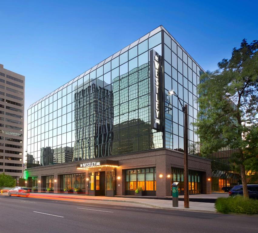 un gran edificio de cristal en una calle de la ciudad en The Westley Calgary Downtown, Tapestry Collection By Hilton en Calgary