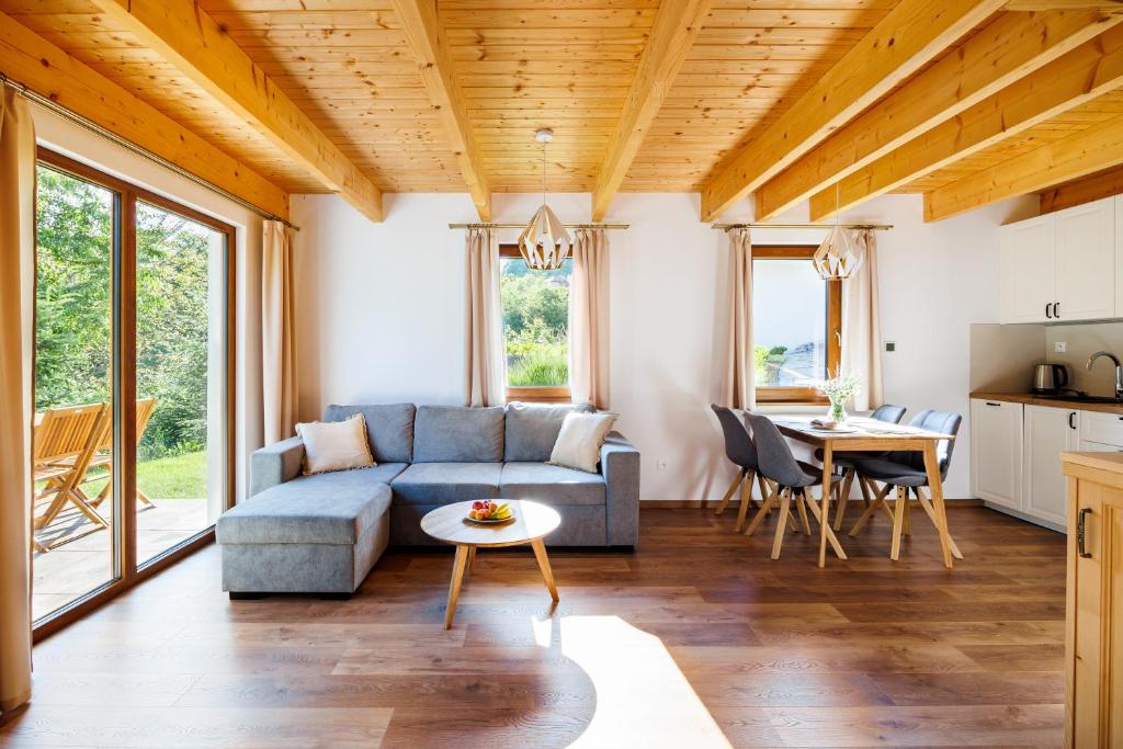 a living room with a couch and a table at Chaty Vážka in Štiavnické Bane