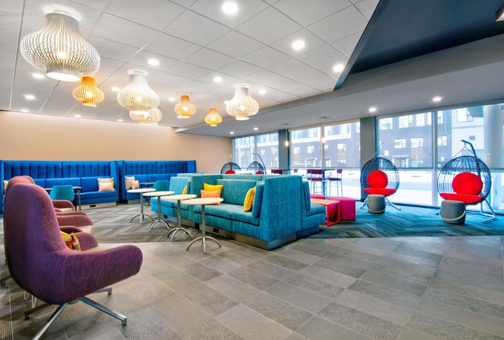 a lobby with couches and tables and chairs at Tru By Hilton Ashburn One Loudoun, Va in Ashburn