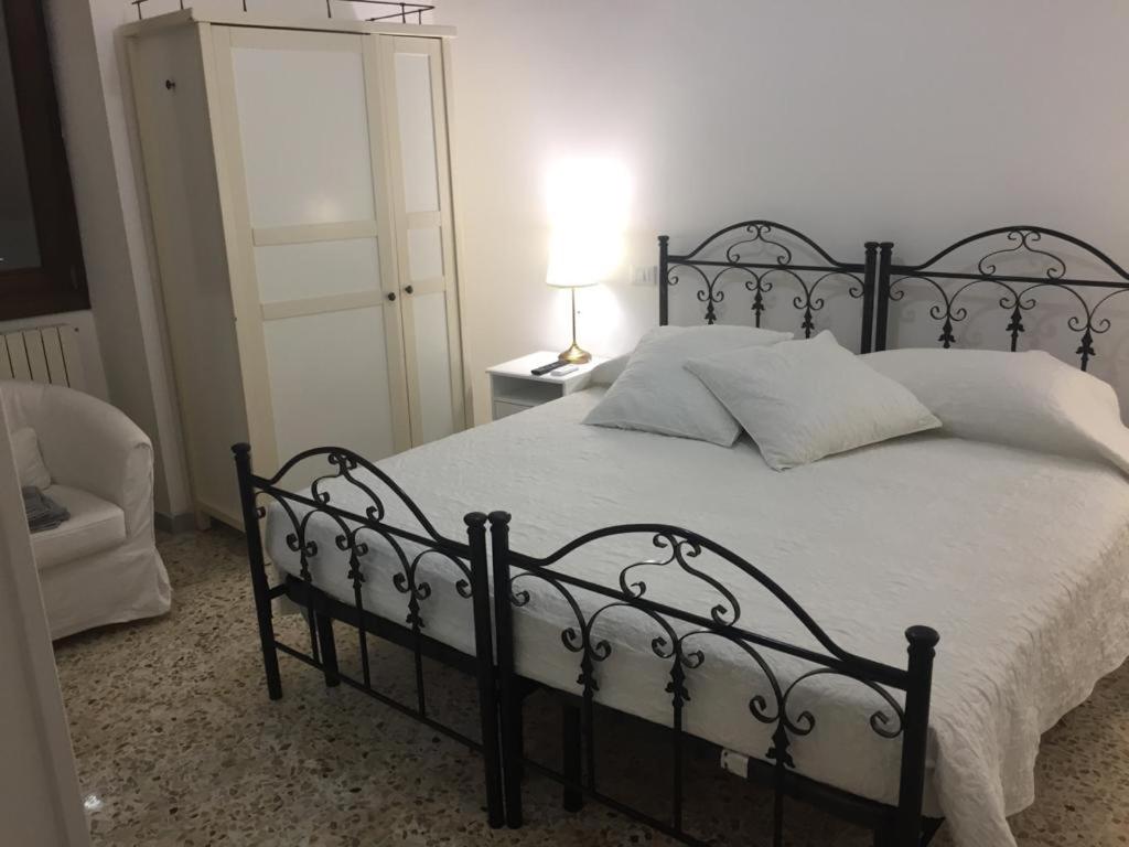 1 dormitorio con cama negra y manta blanca en Villino Donna Rita, en Lecce