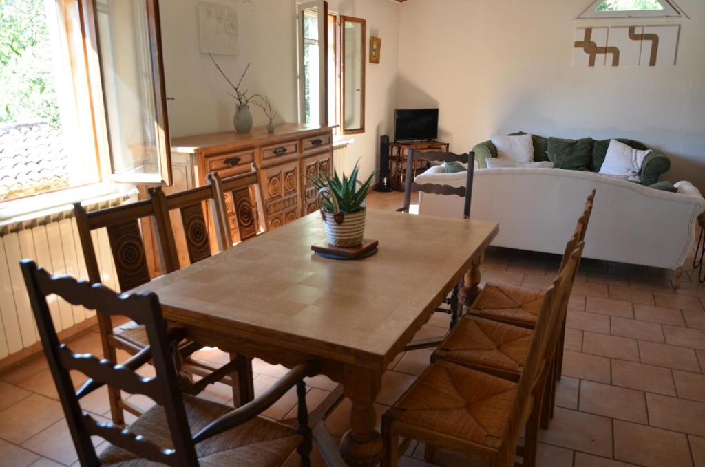 a living room with a table and chairs and a couch at Maison Amandre en Pleine Nature - Mas Lou Castanea in Collobrières