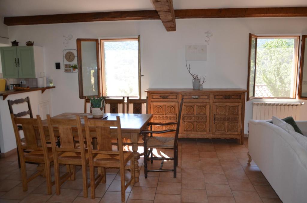 a kitchen and dining room with a table and chairs at Maison Amandre en Pleine Nature - Mas Lou Castanea in Collobrières