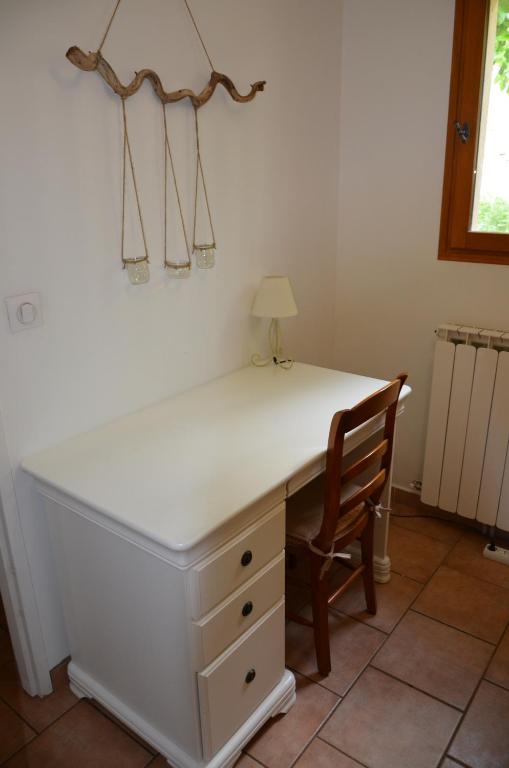 a white desk with a chair and a lamp at Maison Amandre en Pleine Nature - Mas Lou Castanea in Collobrières