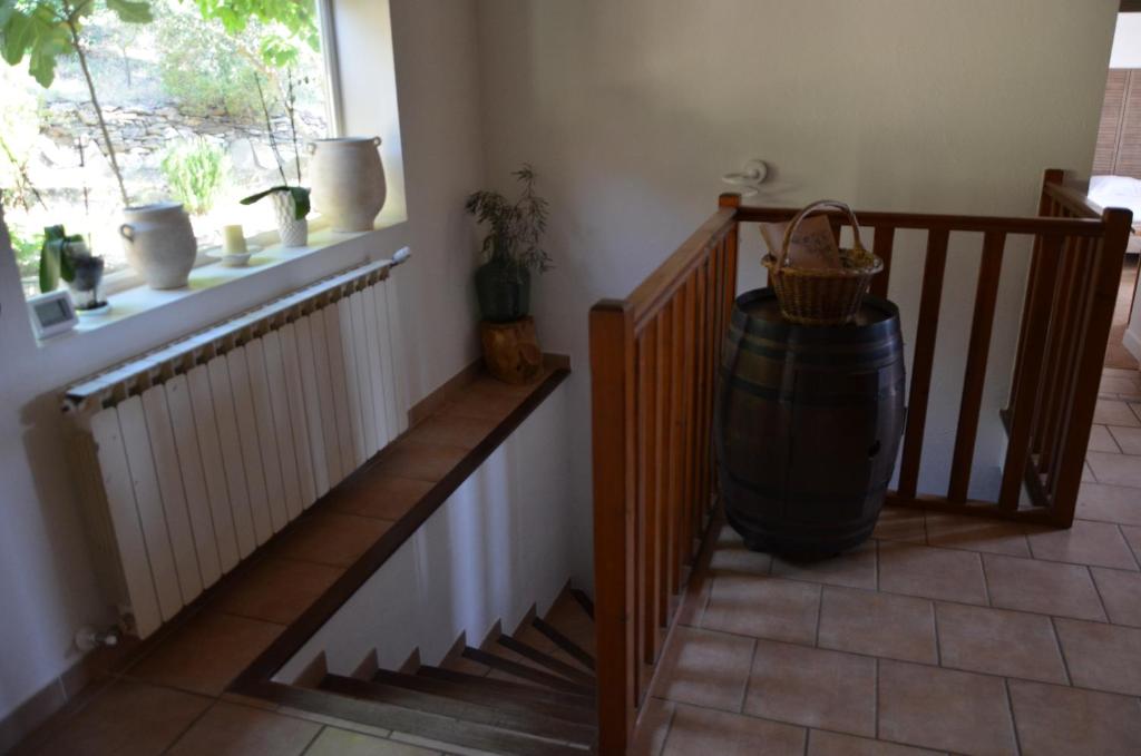 a room with a staircase with a barrel and a window at Maison Amandre en Pleine Nature - Mas Lou Castanea in Collobrières