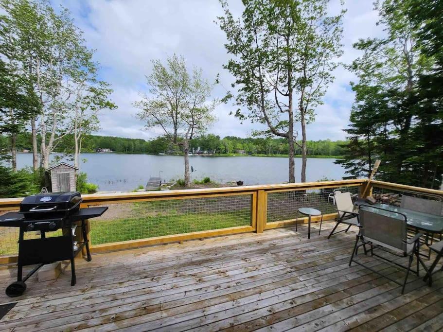 a wooden deck with a view of a lake at CAIA Lakeside Retreat - Sunken Lake in New Minas