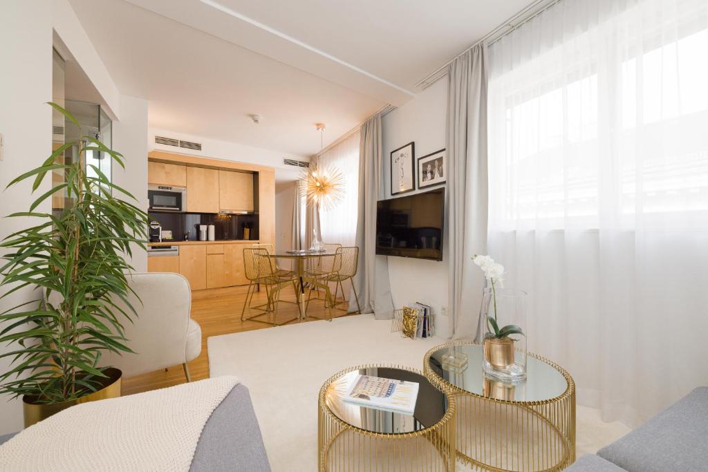a living room with a couch and a table at Rafael Kaiser - Premium Apartments City Centre - Contactless 24h Check-In in Vienna