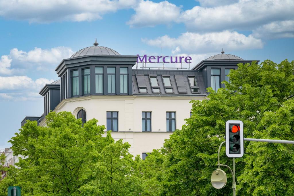 a building with a sign on top of it at Mercure Berlin Wittenbergplatz in Berlin