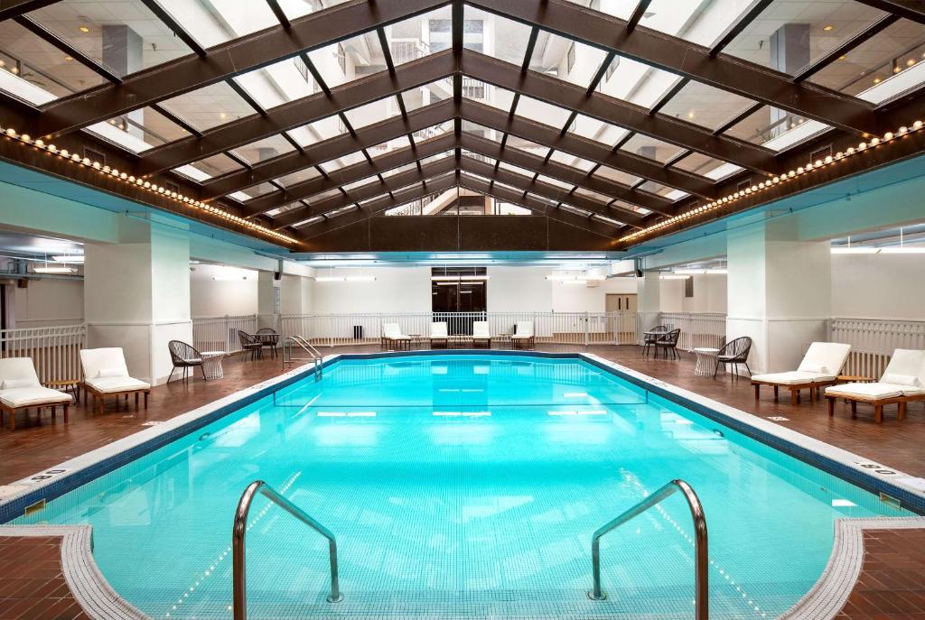a large indoor pool with a large ceiling at Hilton Appleton Paper Valley in Appleton