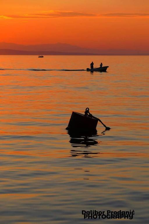 two people in a boat on the water at sunset at Dalibor in Senj