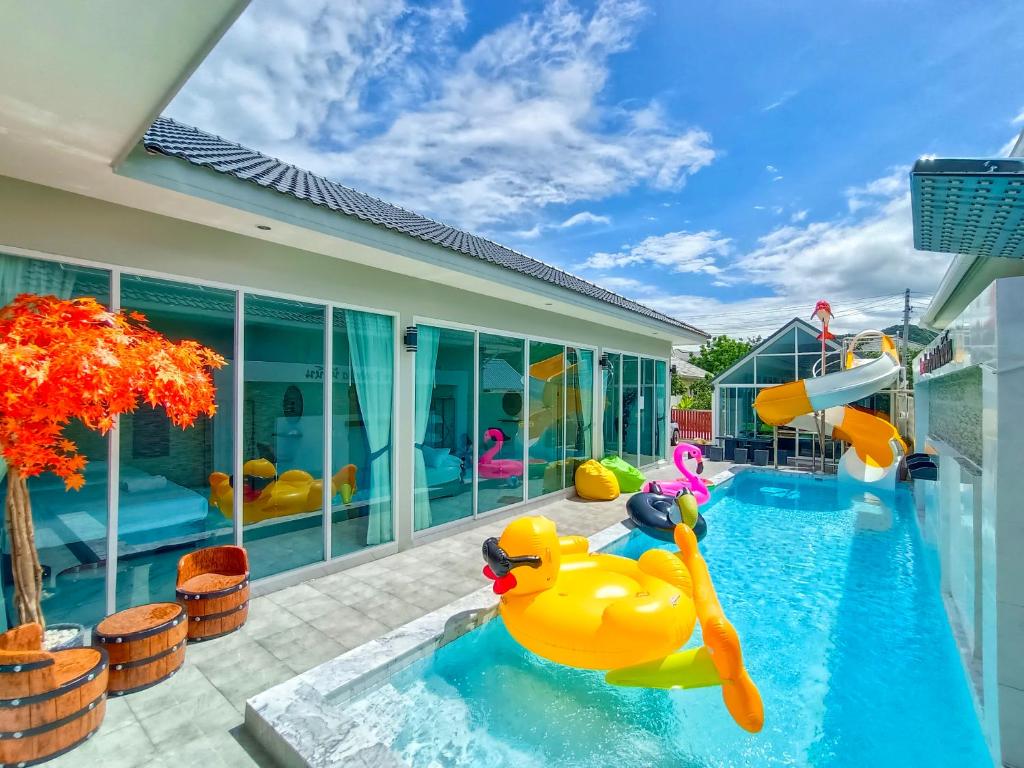 a swimming pool with a rubber duck in the water at Love Here Poolvilla หัวหิน in Hua Hin