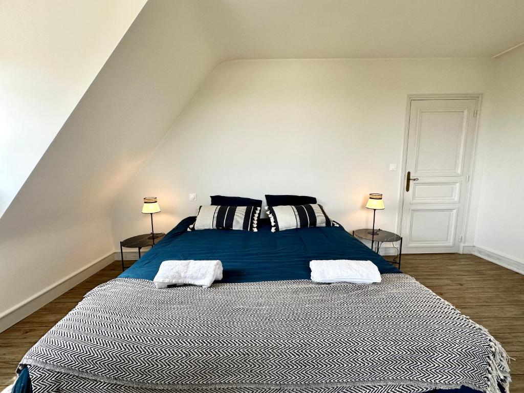 a bedroom with a large blue bed with two lamps at LUXURY ! Maison spacieuse de standing – Proche des plages in Ploemeur