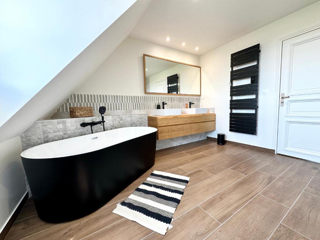 a bathroom with a large tub and a sink at LUXURY ! Maison spacieuse de standing – Proche des plages in Ploemeur