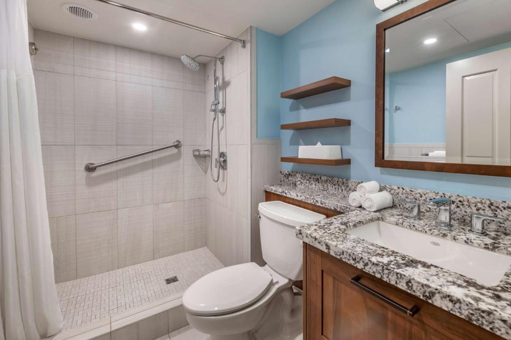 a bathroom with a toilet and a sink and a shower at Hilton Vacation Club Flamingo Beach Sint Maarten in Simpson Bay