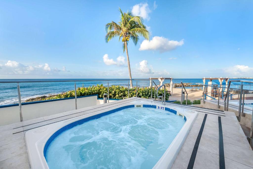 a hot tub on a balcony overlooking the beach at Hilton Vacation Club Flamingo Beach Sint Maarten in Simpson Bay