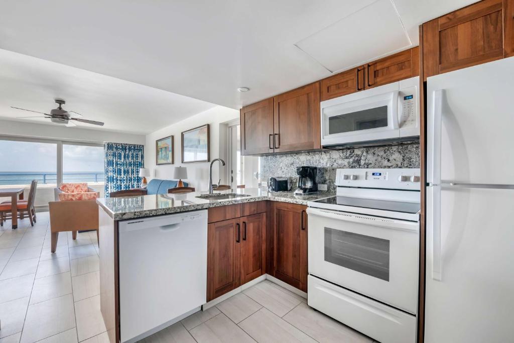 a kitchen with white appliances and a view of the ocean at Hilton Vacation Club Flamingo Beach Sint Maarten in Simpson Bay