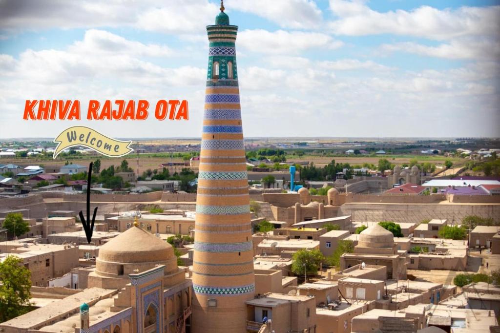 a mosque in the middle of a city with a tall tower at Khiva Rajab Ota in Khiva