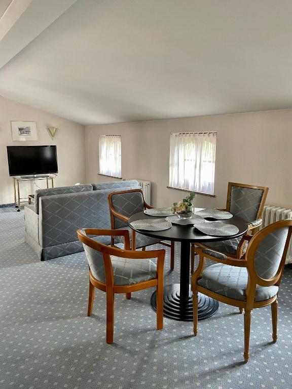 a living room with a table and chairs and a couch at Antonappartements in Dresden