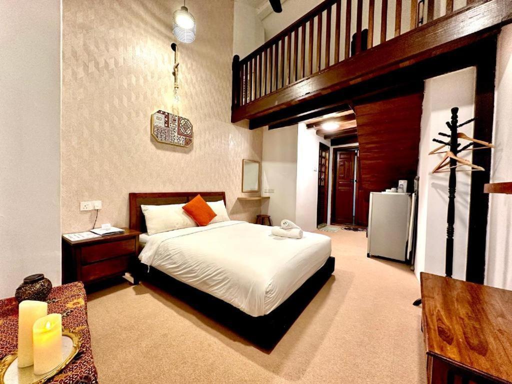 a bedroom with a large bed and a staircase at Le Meilleur in George Town