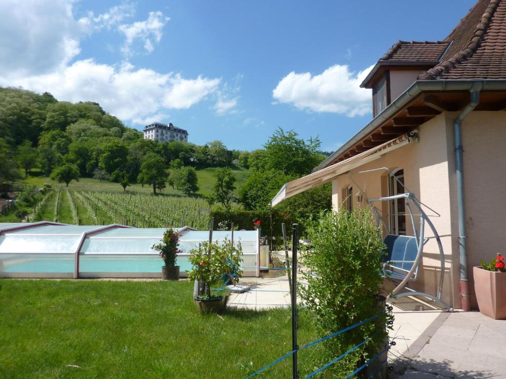 a house with a swimming pool in a yard at LA FERME DES PERLES NOIRES in Ribeauvillé