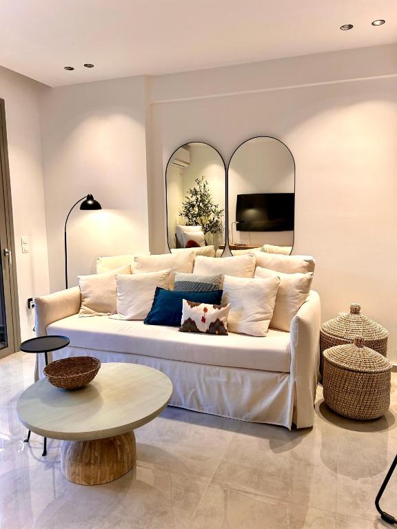 a living room with a white couch and a table at O live Kalamata in Kalamata