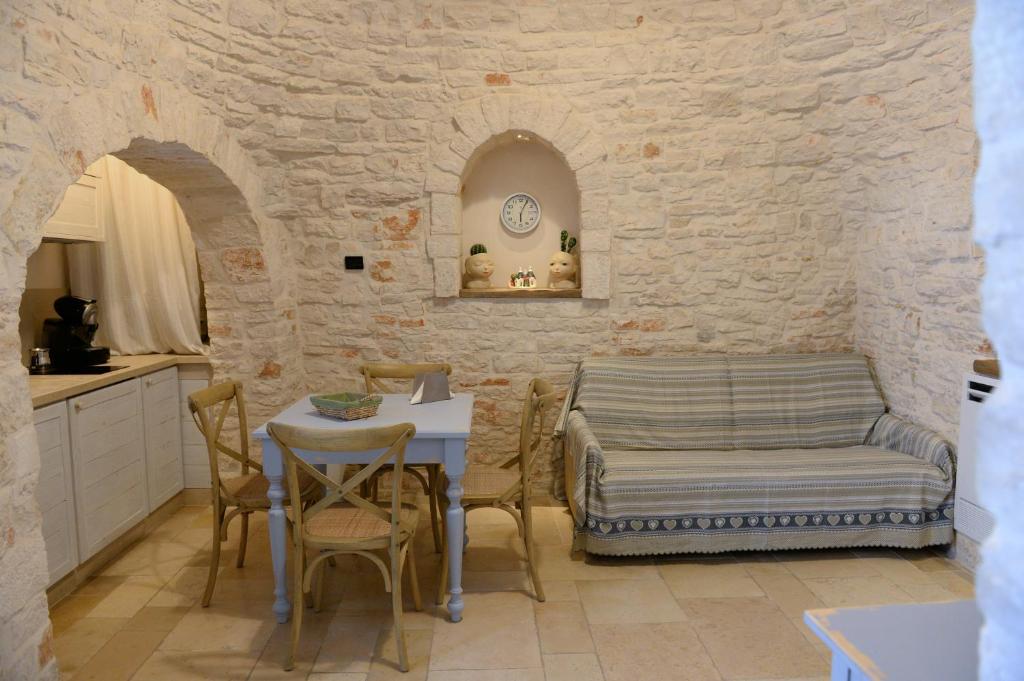 una cucina con tavolo e sedie in una stanza di Trullo A Casedd ad Alberobello