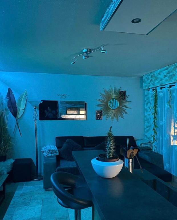 uma sala de estar com uma mesa com uma planta em Joli T2 ,50 m des plages, 4 pers , en rez de jardin em Fréjus