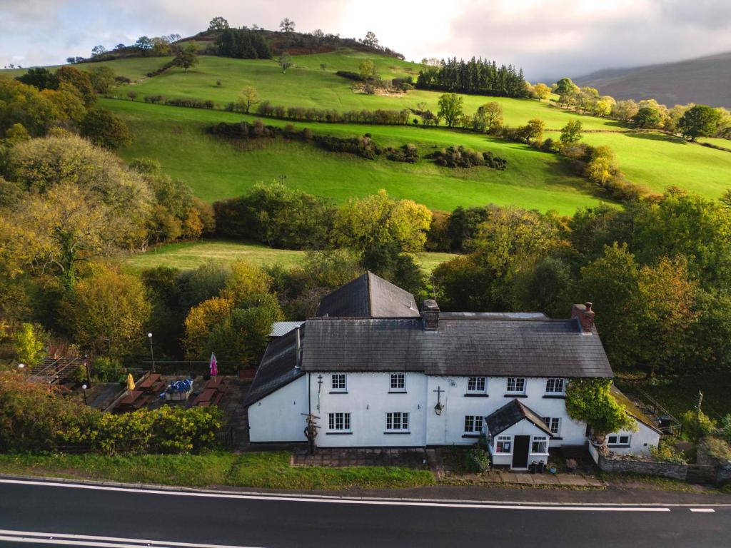 a white house on the side of a road at Dinas Castle Inn (The Dragons Back) in Brecon