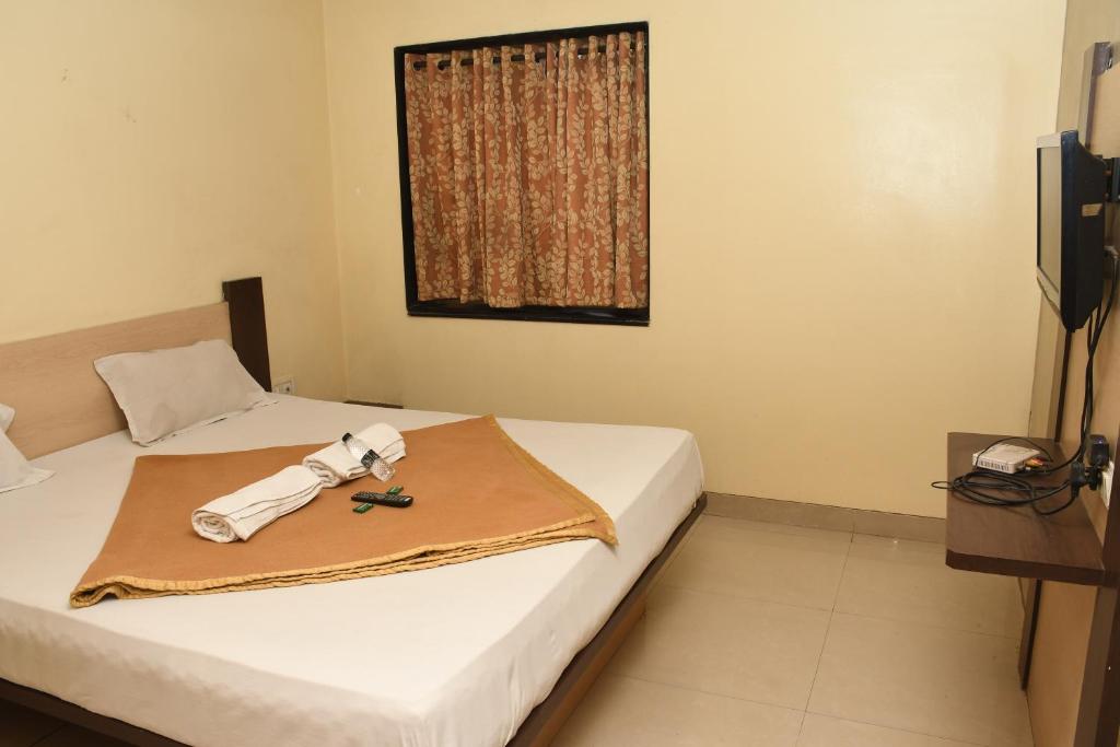 Postel nebo postele na pokoji v ubytování Hotel Sachin