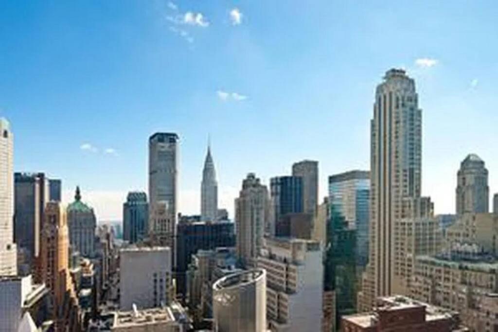 a view of a city skyline with tall buildings at Luxurious 1BD Apartment Steps from Times Square in New York