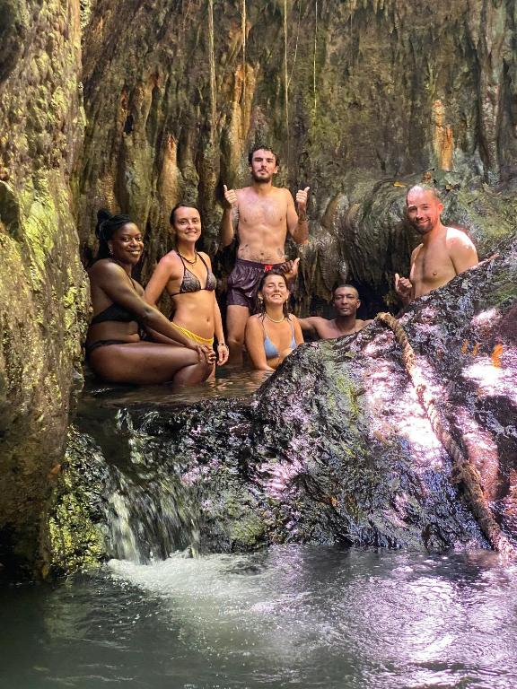 a group of people sitting in the water in a cave at Utria hostel in El Valle