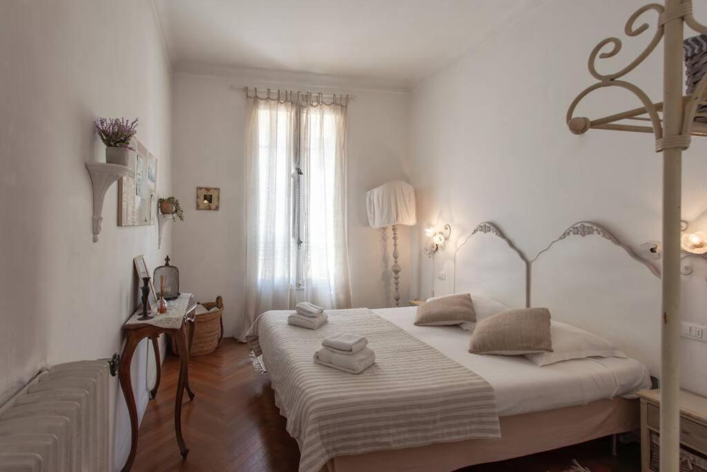 a white bedroom with a large bed and a window at #41 Central & charming 1 BDR flat 10mins walk to beach in Nice
