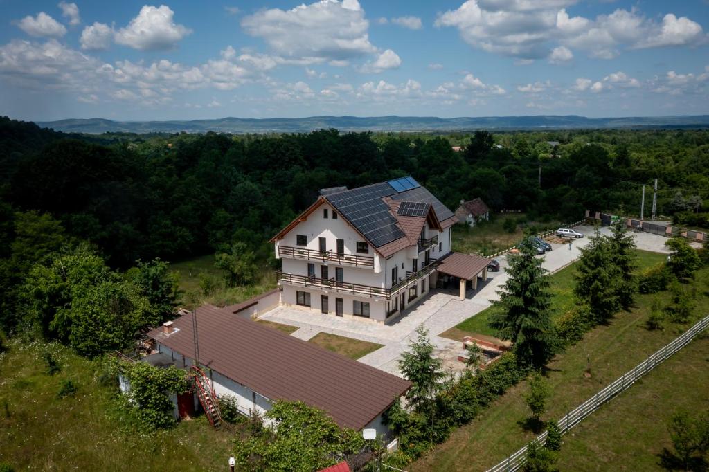 an aerial view of a large house on a hill at Evergreen Chalet in Avrig